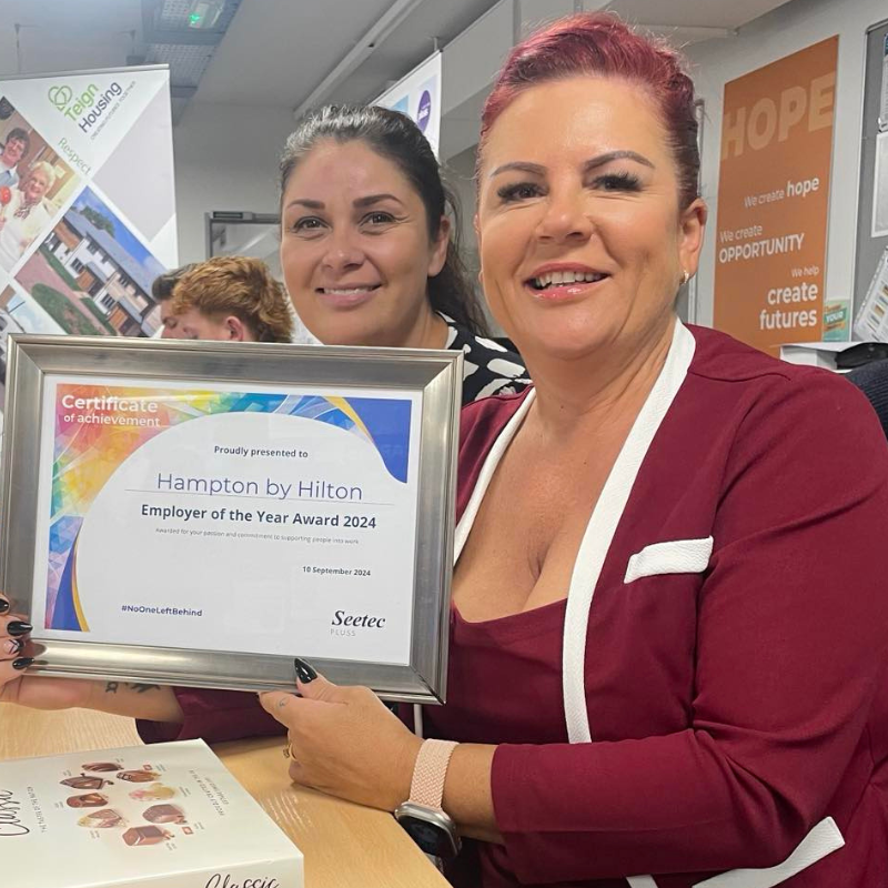 A proud Disability Confident employer shows off her certificate