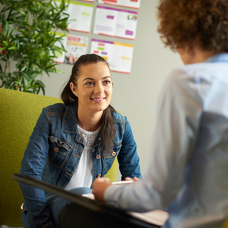 Young female talks to their work coach.