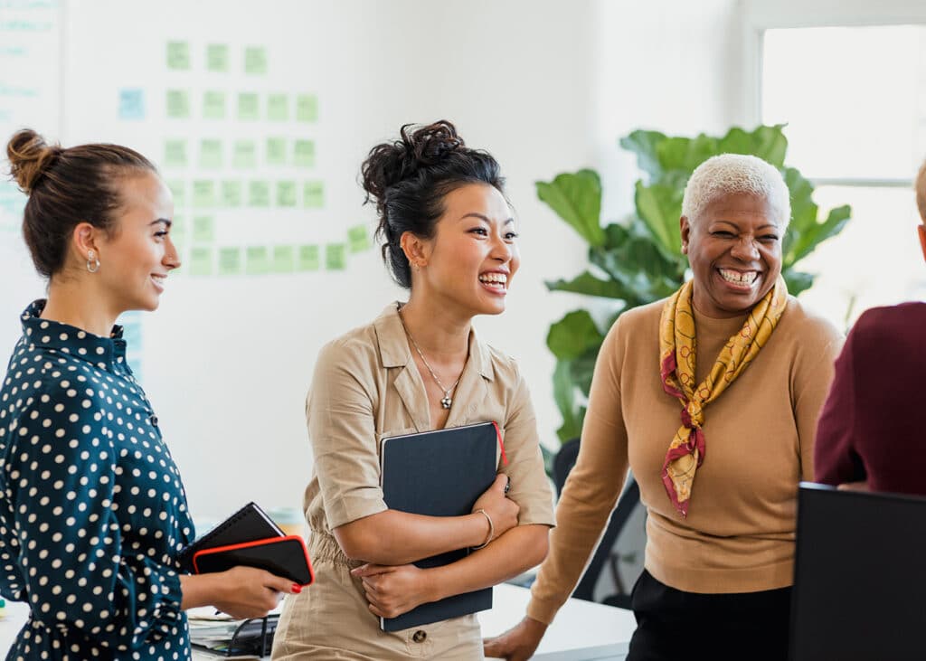 Group of business colleagues smiling together in their office.