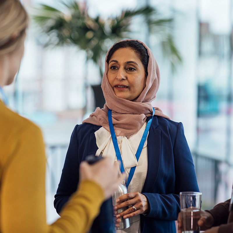 Professionals networking with each other at a business conference.