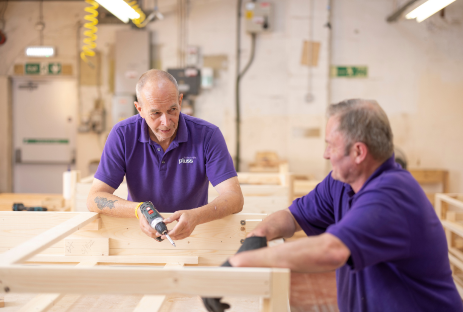 Pluss colleagues talking and working at the manufacturing plant in Barnstaple